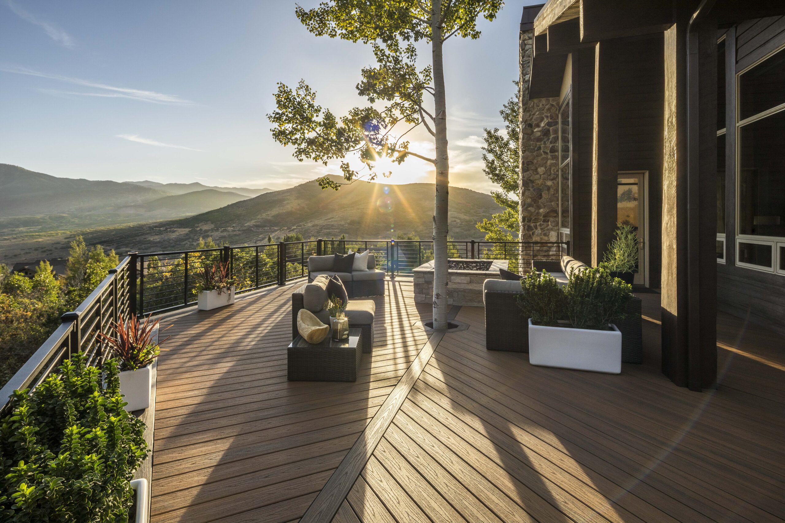 expansive deck built with Trex decking with a mountain scene at sunset